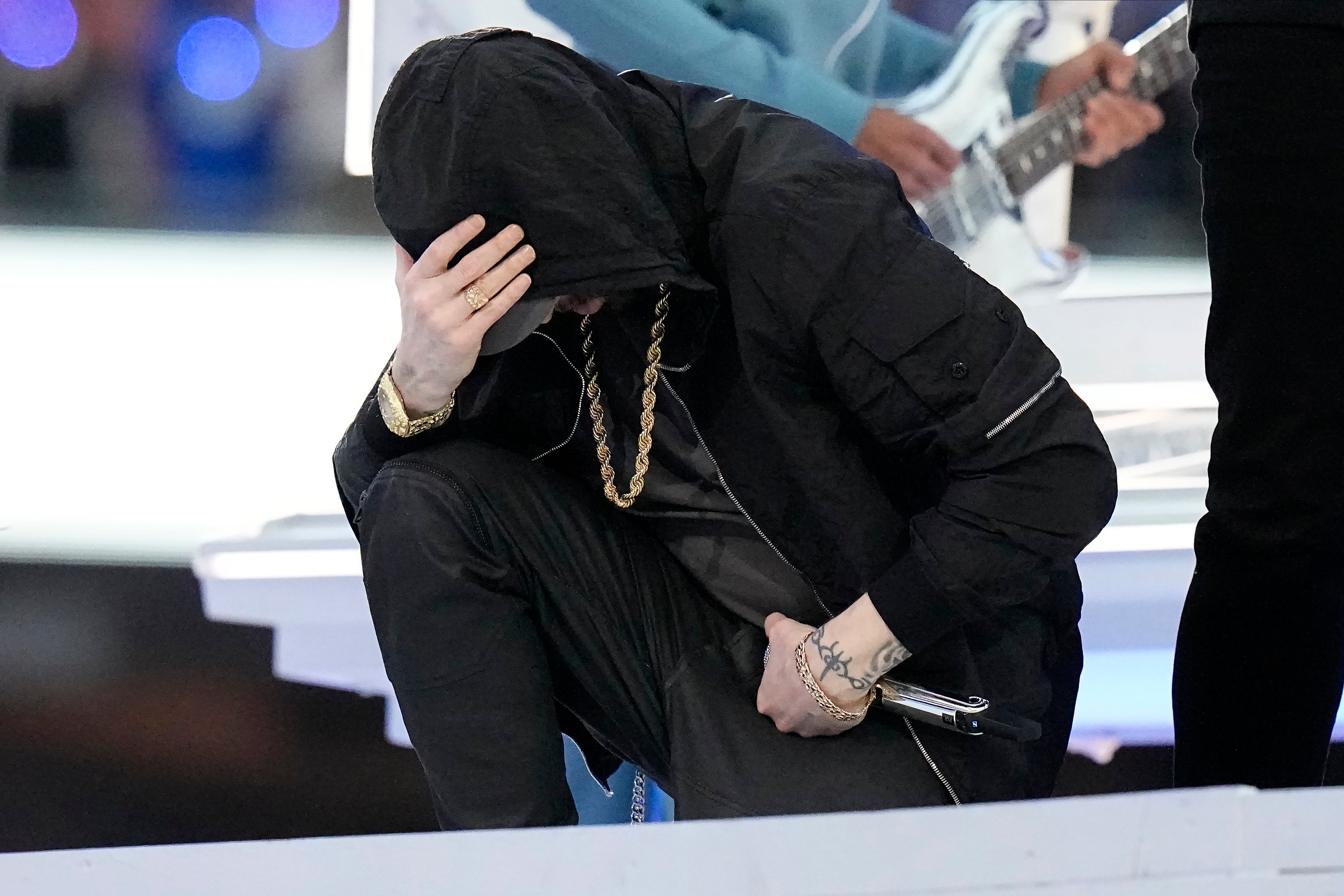 Eminem kneels during the Super Bowl Halftime Show.