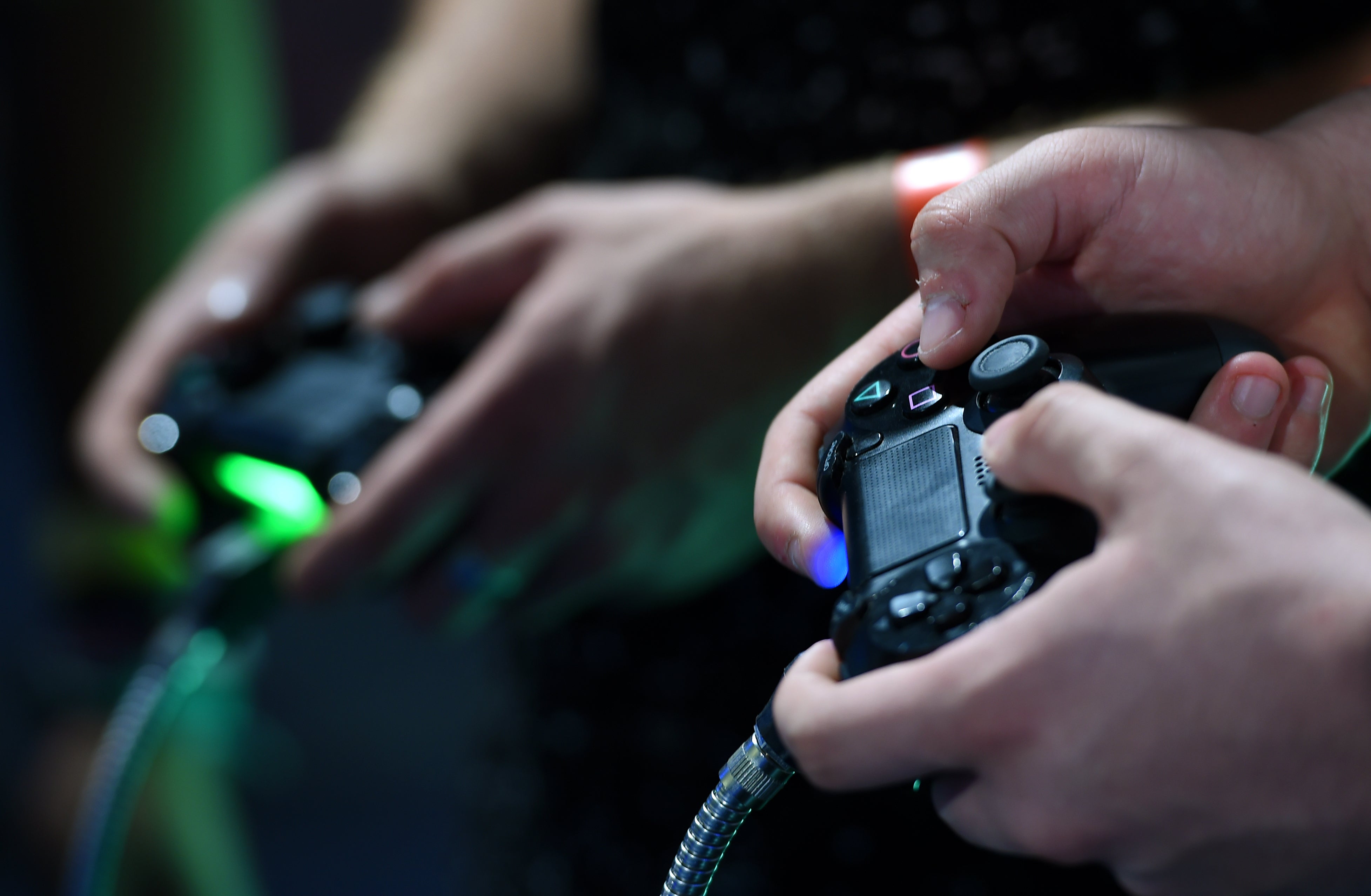 Gamers play on a Playstation 4 during EGX 2016 at the NEC in Birmingham (Joe Giddens/PA)