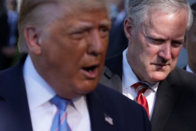 <p>Donald Trump speaks as White House Chief of Staff Mark Meadows (R) listens prior to Trump's Marine One departure from the South Lawn of the White House July 29, 2020 in Washington, DC. </p>