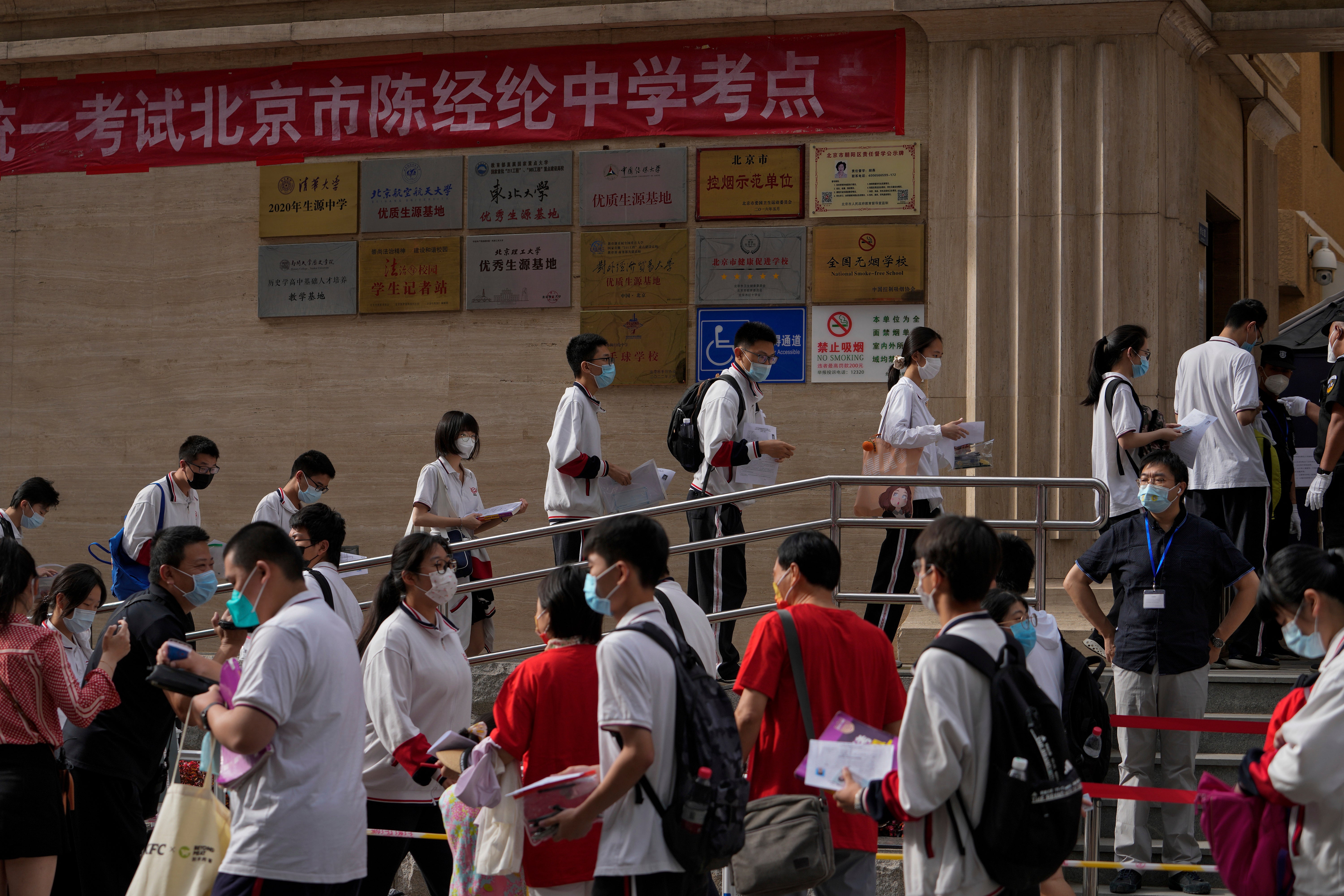 File. Students line up to enter a school for the first day of China's national college entrance examinations in Beijing on 7 June 2022