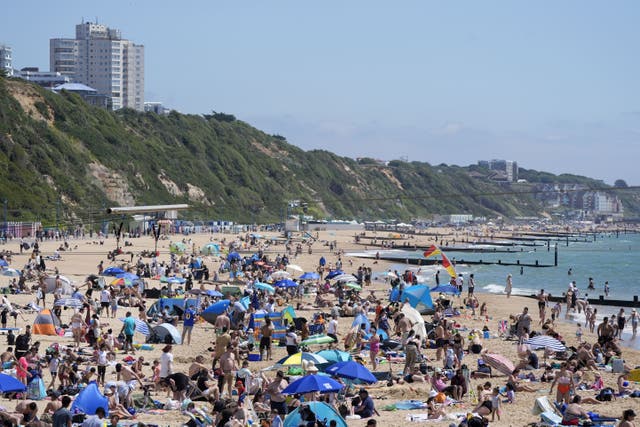 <p>People enjoy sunny weather on Bournemouth Beach (PA)</p>