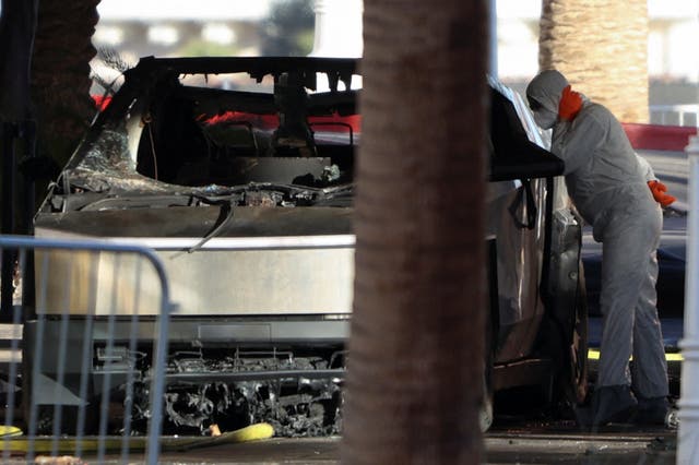 <p>Firefighters work at the Tesla Cybertruck which burned at the entrance of Trump Tower in Las Vegas</p>