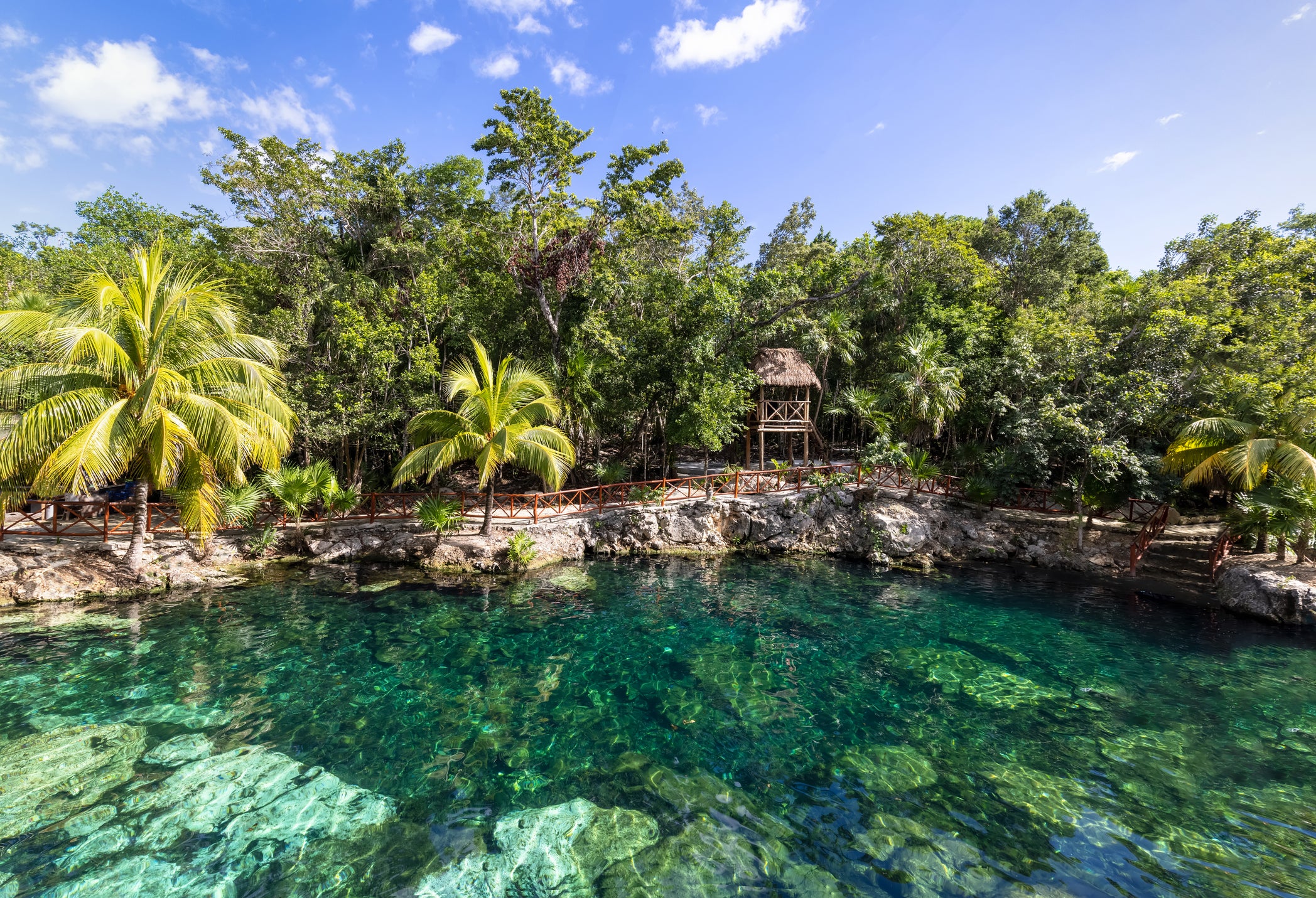 Tulum is characterised by rugged coastal cliffs and inland cenotes