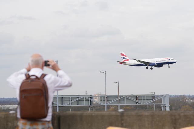 <p>People watch a British Airways plane at Heathrow on Saturday (Maja Smiejkowska/PA)</p>
