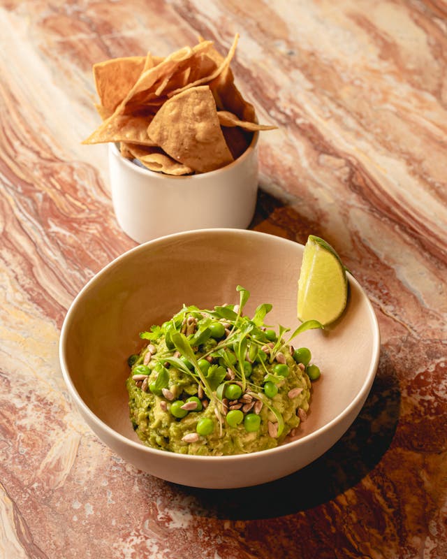 <p>Sweet pea guacamole with charred jalapeño and sunflower seeds – a spring-fresh twist on a classic</p>
