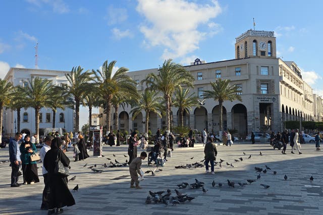 <p>Libyans walk around in Tripoli's Martyrs Square on April 28, 2025</p>